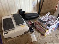 LegXercise stepper, adapter, ankle weights and Wonder Arms box on floor