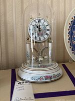 Front view of Linden anniversary clock under glass dome