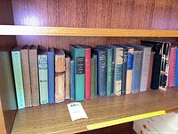 Shelf showing full run of approximately 23 cloth-bound books