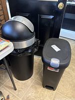 Both trash cans side by side showing overall design and size contrast