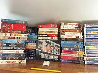 Overall view showing multiple stacks of VHS tapes and Honeymooners box set