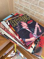 Stack of concert programs, AC/DC cover visible