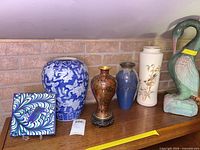 All six decorative pieces arranged on shelf