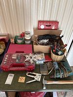 Overall lot on table with tools, cases, cords, tapes