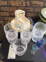 Tumblers, rocks glass, ceramic bassinet box, partial souvenir plate