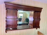 Front view showing full wall mirror shelf with glass shelves and mahogany frame