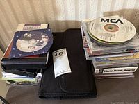 Overall lot: CD stacks, CD wallet, numbered tag visible