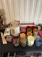 Table view of wax warmer, jar candles, loose pillars, votive holders, boxed candles