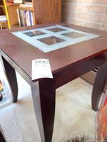 full view of end table showing shape, legs and glass inset