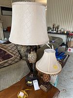 Both table lamps with shades on side table