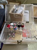 open clear plastic sewing box showing contents