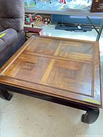 overall view of square coffee table beside sofa