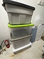 Stack of six large Sterilite bins showing assorted lid colours