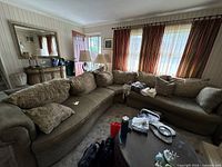 Full view of taupe curved sectional with pillows