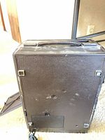 Full rear/side view of brown projector, handle on top, power cord visible