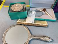 Full set laid out: mirror, jar, comb, compact, brush