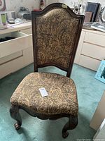 Full view of dining chair showing upholstery and wooden frame