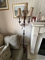 Full view of floor lamp beside sofa and fireplace