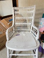 Front view of white wicker and wood armchair