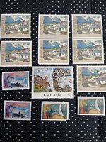 All twelve Canadian stamps arranged on black dotted background