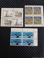 Overview of three mint stamp blocks of four on patterned background