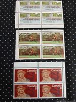 All three blocks of stamps displayed on black dotted background