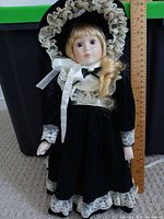 Full view of doll beside ruler showing height