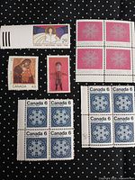 Overall lot showing blocks and singles: 29¢ angel, 43¢ Madonna & Child, 35¢ performer, 10¢ magenta snowflake block, 6¢ blue snowflake block
