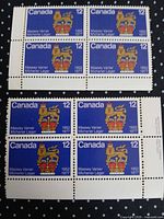 Two blocks of four Canadian 12 ¢ Massey Vanier / Michener Léger stamps displayed front view