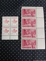 Block of four A stamps and vertical strip of four $1 stamps displayed on dark background