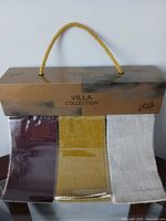 Front view showing Villa Collection cover, rope handle, three visible swatches