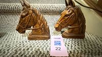 Front view of both horse head bookends on stairs