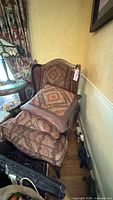 Full view of patterned wingback chair with cushions