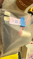 Sealed plastic bag containing black and pink seat cover