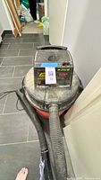 Full view of Craftsman wet/dry shop vacuum with hose attached