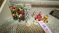overview showing three tubes of jingle bells, four metallic bell ornaments and two ceramic bell ornaments on staircase