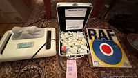 All three items: massager, open domino case, RAF board game