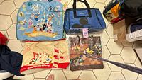 Overview of all four Disney bags laid out on floor