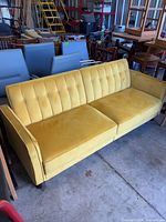 Full view of mustard yellow velvet three-seat sofa