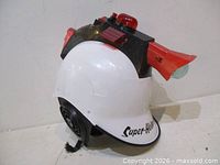 Left front view showing white helmet shell, black module, red beacon, fins, Super-Helmet decal