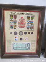 Front view of framed Centennial Collection showing coins, stamps, banknote and provincial crests