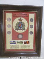 Full view of framed RCMP commemorative coin and stamp display