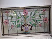 Full view of stained glass panel showing floral design and wood frame