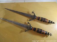 Both daggers full length on tabletop