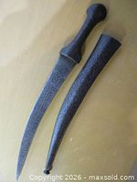 Full view of dagger beside sheath