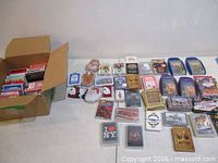 All decks arranged on table plus open box of additional decks