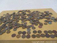 Wide view of scattered Canadian pennies on tabletop