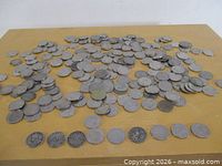 Wide view of large pile of Canadian 5-cent coins on table