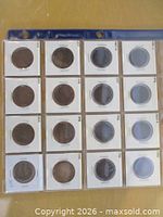 Binder page holding 16 coin flips front view