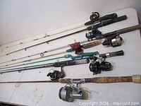 All eight rods laid on table showing reels and handles